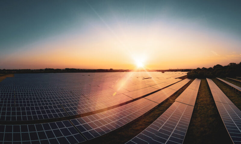 Modern solar farm panoramic at sunrise on a summers day